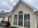 Sunroom addition with arched window and white shutters at 104 Masters N Dr, Peachtree City, GA 30269