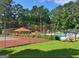 View of community amenities, including the pool, tennis court, and pool house at 215 Kingswood Dr, Fayetteville, GA 30215