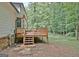 Backyard featuring deck, steps and mature trees at 215 Kingswood Dr, Fayetteville, GA 30215