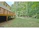 Backyard featuring large deck and wooded perimeter at 215 Kingswood Dr, Fayetteville, GA 30215