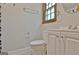 Bathroom featuring a toilet, modern vanity, and a window offering natural light at 215 Kingswood Dr, Fayetteville, GA 30215