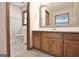 Bathroom featuring a wood vanity with white countertops, a decorative mirror, and a toilet at 215 Kingswood Dr, Fayetteville, GA 30215