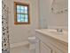 Bright bathroom with white vanity, round mirror, window, toilet, and patterned shower curtain at 215 Kingswood Dr, Fayetteville, GA 30215