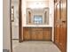 Bathroom with wooden vanity, large mirror, carpet, and view of a second full bathroom at 215 Kingswood Dr, Fayetteville, GA 30215