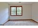 Bedroom with large window, neutral carpet and paint, baseboard trim and wall outlets at 215 Kingswood Dr, Fayetteville, GA 30215