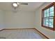 Bedroom featuring carpet, ceiling fan and window for ample natural light at 215 Kingswood Dr, Fayetteville, GA 30215