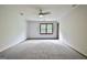 Large bedroom with carpet, neutral walls, ceiling fan and a bright window providing plenty of light at 215 Kingswood Dr, Fayetteville, GA 30215