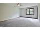 Spacious bedroom featuring carpet, neutral walls, and a window providing natural light at 215 Kingswood Dr, Fayetteville, GA 30215