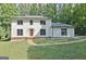 Inviting two-story home with a classic design and well-maintained lawn and landscaping at 215 Kingswood Dr, Fayetteville, GA 30215