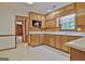 Kitchen boasts wood cabinets, tile flooring, and microwave at 215 Kingswood Dr, Fayetteville, GA 30215