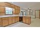 Eat-in kitchen features wooden cabinets, laminate countertops, and tile flooring at 215 Kingswood Dr, Fayetteville, GA 30215