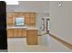 Kitchen with wood cabinets, tile floor and island at 215 Kingswood Dr, Fayetteville, GA 30215