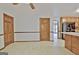 Eat-in kitchen area featuring tiled floor and wooden cabinets with adjoining rooms at 215 Kingswood Dr, Fayetteville, GA 30215