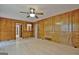Living room with wood paneling, light hardwood floors, and multiple entryways at 215 Kingswood Dr, Fayetteville, GA 30215