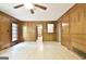 Living room featuring wood paneling, light hardwood floors, and multiple doorways at 215 Kingswood Dr, Fayetteville, GA 30215