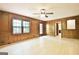 Living room with wood paneling, light hardwood floors, and large window at 215 Kingswood Dr, Fayetteville, GA 30215