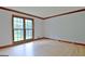 Living room with hardwood floors, large window, and wood trim at 215 Kingswood Dr, Fayetteville, GA 30215