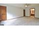 This spacious primary bedroom has a ceiling fan, carpet, and doors to the bathroom and closets at 215 Kingswood Dr, Fayetteville, GA 30215