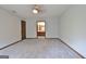 Spacious primary bedroom with carpet, doors to the bathroom and closets, and a ceiling fan at 215 Kingswood Dr, Fayetteville, GA 30215