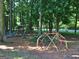 Community playground area with swings, slide and dome climber, all on wood chip ground at 215 Kingswood Dr, Fayetteville, GA 30215