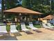 The community pool offers both sun and shade along with plenty of lounge chairs for relaxing at 215 Kingswood Dr, Fayetteville, GA 30215