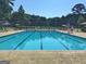 Community pool with clear blue water, lap lanes, and plenty of lounge chairs at 215 Kingswood Dr, Fayetteville, GA 30215
