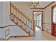 Elegant staircase with wooden railing and carpeting at 215 Kingswood Dr, Fayetteville, GA 30215