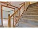 Wooden staircase with carpeted steps and wooden railing at 215 Kingswood Dr, Fayetteville, GA 30215