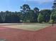 Community tennis court with net. Surrounded by fencing and tall shade trees at 215 Kingswood Dr, Fayetteville, GA 30215