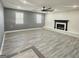 Spacious living room with fireplace, gray walls, and wood-look flooring at 755 Tanner Rd, Dacula, GA 30019