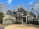 Two-story house with a large front porch and attached garage at 306 Oakwind Way, Canton, GA 30114