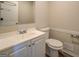 Clean bathroom with white vanity, toilet and wood-look flooring at 169 Holly Ct, Loganville, GA 30052