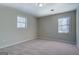 Well-lit bedroom featuring two windows at 169 Holly Ct, Loganville, GA 30052