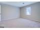 Bright bedroom with carpeted floor and window at 169 Holly Ct, Loganville, GA 30052
