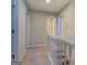 Upstairs hallway with white railing and carpet at 169 Holly Ct, Loganville, GA 30052