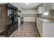 Modern kitchen with white cabinets, granite countertops, and black appliances at 169 Holly Ct, Loganville, GA 30052