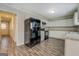 Modern kitchen with white cabinets, granite countertops, and stainless steel appliances at 169 Holly Ct, Loganville, GA 30052