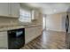 Modern kitchen with white cabinets, granite countertops, and black appliances at 169 Holly Ct, Loganville, GA 30052