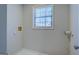 Small laundry room with window and hookups at 169 Holly Ct, Loganville, GA 30052