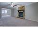 Open living room with carpet and fireplace at 169 Holly Ct, Loganville, GA 30052