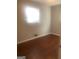 Simple bedroom with hardwood floors and a window at 2176 Lilac Ln, Decatur, GA 30032