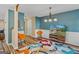 Bright living room with hardwood floors, colorful rug, and a TV at 149 Pristine Dr, Locust Grove, GA 30248