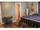 Bedroom featuring hardwood floors, neutral walls, and view to an ensuite bathroom at 106 Gwenellen Dr, Locust Grove, GA 30248