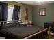 Bedroom with green walls, a black comforter, and a window with black curtains at 106 Gwenellen Dr, Locust Grove, GA 30248