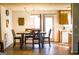 Dining area featuring wood-look flooring, wooden table and chairs, and view to kitchen at 106 Gwenellen Dr, Locust Grove, GA 30248