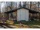 This outdoor shed includes an attached lean-to, offering shade and coverage for all your outdoor storage needs at 106 Gwenellen Dr, Locust Grove, GA 30248
