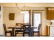 Dining area with wooden table and chairs, plus bright natural lighting at 106 Gwenellen Dr, Locust Grove, GA 30248