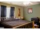 Bedroom with green walls, a black comforter, and a window with black curtains at 106 Gwenellen Dr, Locust Grove, GA 30248