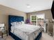 Bedroom with blue velvet headboard and window at 7356 Blue Jay Way, Union City, GA 30291