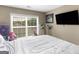 Bright bedroom featuring a large window with blinds and a flat-screen TV at 7356 Blue Jay Way, Union City, GA 30291